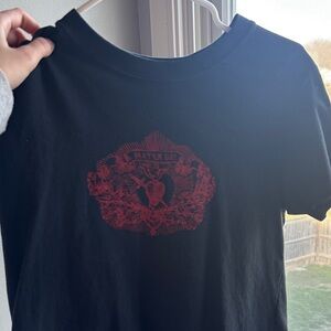 brandy melville (john galt) Black Graphic Tee with Red Crest Design